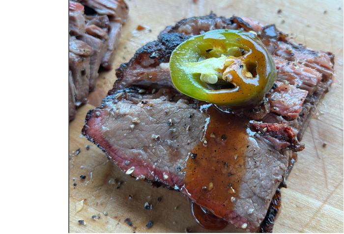 Texas-style Prime Brisket sliced on a cutting board